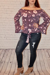Off the shoulder knit top featuring ruffled bell sleeves and front self-tie knot